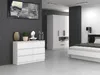 A modern bedroom with a dresser, wardrobe, and bed. Anteprima dell’immagine prodotto