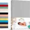 A product image showing a stack of fitted sheets in various colors on the left and a close-up of a folded fitted sheet with marketing information and a person sleeping on a bed on the right. Produktbild-Vorschau