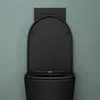 A black matte toilet with the lid up, mounted on a light teal wall. Produktbild-Vorschau