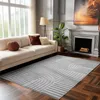 A living room scene featuring a sofa, fireplace, and a rug.