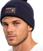 Close-up portrait of a man wearing a navy blue beanie with the Oracle Red Bull Racing logo. Anteprima dell’immagine prodotto