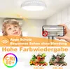 A child looking up at a ceiling light, with a phone showing a glare-free view of the light, and images of vegetables with CRI ratings. Produktbild-Vorschau