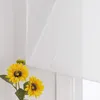 A close-up of two artificial sunflowers in a vase, placed in front of a white sheer roller blind. Produktbild-Vorschau