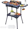 An electric grill with food and accessories on a white background. Produktbild-Vorschau