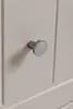 A close-up of a drawer knob on a beige cabinet. Náhľad obrázku produktu