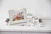 A silver tray with a framed photo and two glasses on a white surface. Produktbild-Vorschau