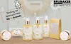 A collection of BRUBAKER Cosmetics products, including lotions, soaps, and creams, displayed on a wooden surface with a decorative mirror in the background. A bunny graphic and text about animal testing are also visible. Produktbild-Vorschau