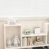A white shelving unit with various decorative items and books. Náhľad obrázku produktu