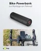 A black power bank is shown above a bicycle handlebar with a phone and cycling computer mounted. Produktbild-Vorschau