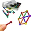 Magnetic building sticks and balls are shown in a tin box and as assembled structures. Náhled obrázku produktu