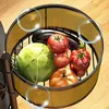 A close-up view of a tiered rolling cart filled with various fresh vegetables. Produktbild-Vorschau