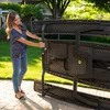 A woman is folding a picnic table in a backyard. Produktbild-Vorschau