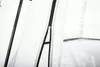 A close-up view of a zipper on a white tent. Podgląd zdjęcia produktu