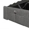 Close-up of a grey upholstered bed frame with integrated USB charging ports and storage pockets. Produktbild-Vorschau