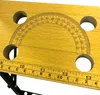 A close-up view of a wooden workbench with a protractor and ruler markings. Náhled obrázku produktu