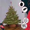 A decorated Christmas tree with a wicker stand, surrounded by decorative icons. Náhľad obrázku produktu