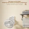 A white wall with a wall-mounted fan and a towel rack with towels. Produktbild-Vorschau