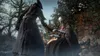 Two figures in dark, hooded cloaks interacting in an outdoor, overgrown setting. Náhled obrázku produktu