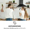 A man and a woman are playfully interacting in a kitchen, holding kitchen utensils as if they were microphones. A black range hood is visible above them. Produktbild-Vorschau