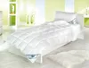 A neatly made bed with a white duvet and pillow in a bright, modern room. Produktbild-Vorschau