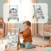 A baby playing with a wooden walker in a nursery. Produktbild-Vorschau
