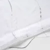 A close-up view of a white and silver roller blind, showing its textured fabric and decorative stitching. Produktbild-Vorschau