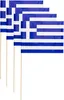 Four small Greek flags on wooden sticks are arranged in a row, overlapping each other. Produktbild-Vorschau