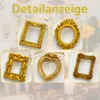 A collage of five different ornate, gold-colored mini picture frames. Produktbild-Vorschau