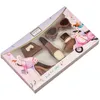 A box of chocolates shaped like fashion items and a scooter, with illustrations of girls on the packaging. Produktbild-Vorschau
