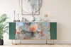 A marble-patterned sideboard with green sides and gold legs, decorated with vases and a plant. Náhľad obrázku produktu