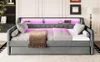 A grey daybed with LED lighting and a blanket is shown in a bedroom setting. Produktbild-Vorschau