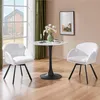 A white swivel chair is shown next to a small round table with a vase of flowers and two candles. Produktbild-Vorschau