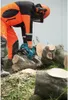 A person wearing protective gear uses a chainsaw to cut logs. Náhled obrázku produktu
