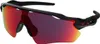 A pair of Oakley sunglasses with red-tinted lenses and a black frame, shown against a white background. Náhled obrázku produktu