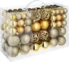 A clear, well-lit studio shot of a set of gold Christmas ornaments in a transparent plastic box. Voir les images du produit