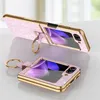 Two pink glitter phone cases with gold trim and ring holders are displayed on a light gray surface with a white background. Produktbild-Vorschau