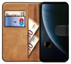 A book-style phone case with cards and cash inserted, next to a smartphone displaying a planetary image. Produktbild-Vorschau