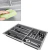 A gray cutlery organizer with various utensils placed inside. Produktbild-Vorschau