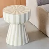 A striped stool next to a sofa. Produktbild-Vorschau