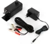 A black electric motor with a knob and a power adapter with a plug and cables are laid out on a white background. Náhled obrázku produktu