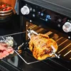A hand is shown placing a rotisserie chicken into a mini oven. Anteprima dell’immagine prodotto