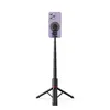 A purple smartphone attached to a black selfie stick with tripod legs, presented against a white background. Produktbild-Vorschau