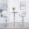 Two white bar stools and a small round table are set up in a room with shelves and a framed picture on the wall. Produktbild-Vorschau
