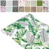 A collage of different patterns and a roll of wallpaper with a tropical leaf pattern. Produktbild-Vorschau