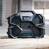 A Bosch professional radio sits on a wooden surface in what appears to be a construction or workshop environment. Produktbild-Vorschau