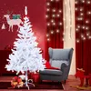 A white Christmas tree is decorated with a red bow and placed in a room with red walls, a gray armchair, and Christmas decorations. Produktbild-Vorschau