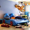 A child's bedroom with a car-shaped bed, desk, and toys. Anteprima dell’immagine prodotto