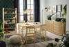 A dining room scene with a wooden bookshelf, dining table and chairs, and a sideboard. Produktbild-Vorschau