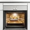 Pears are being baked in a pan inside an oven. Náhľad obrázku produktu