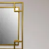 A close-up view of a decorative gold mirror frame. Produktbild-Vorschau